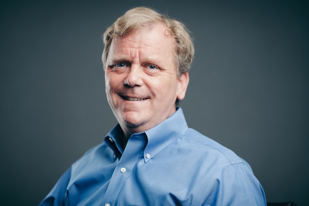 Studio portrait of a man in a blue shirt